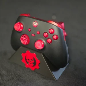 Black and red gaming controller on stand.